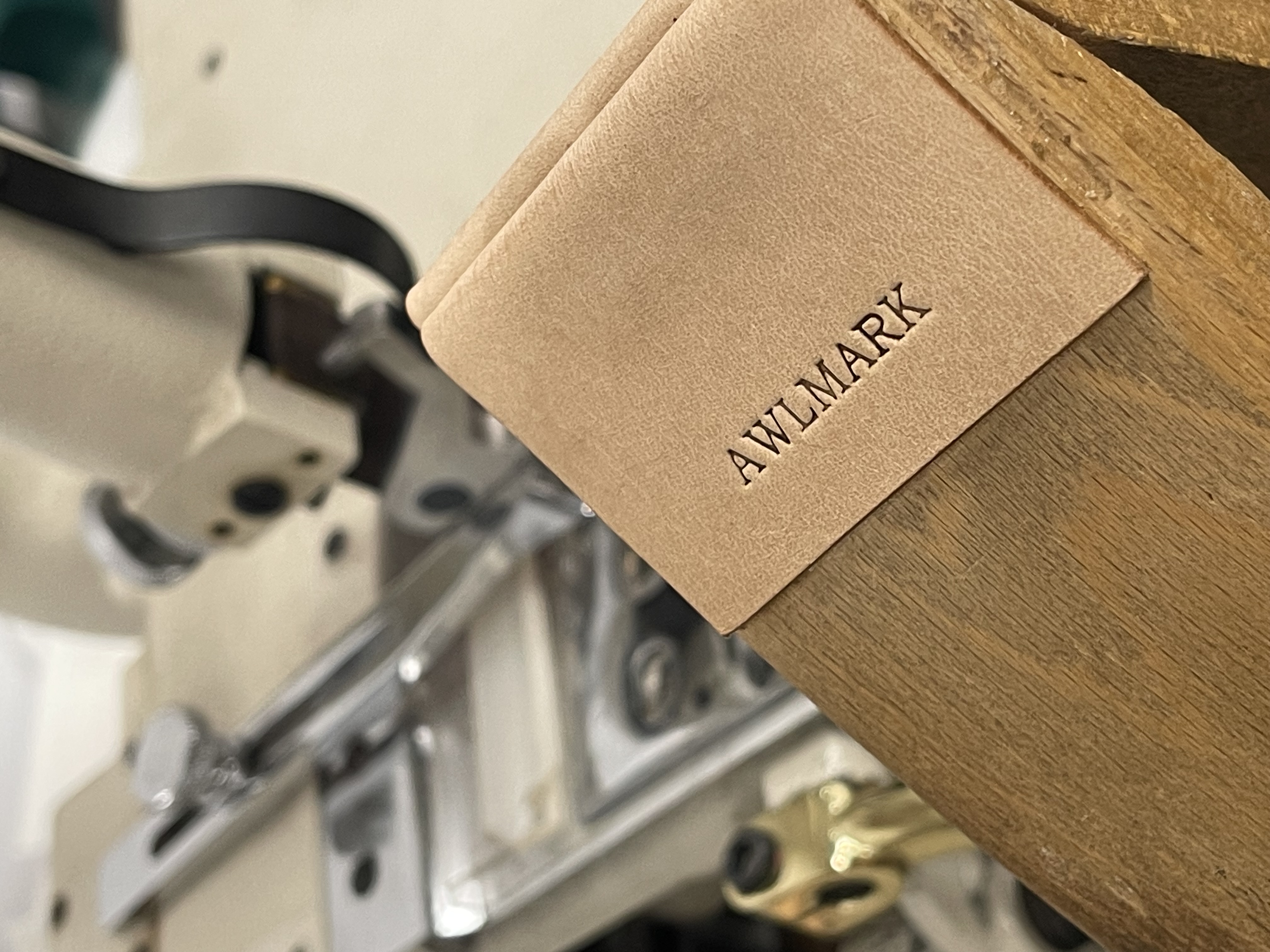 The Awlmark maker's mark pressed into natural leather